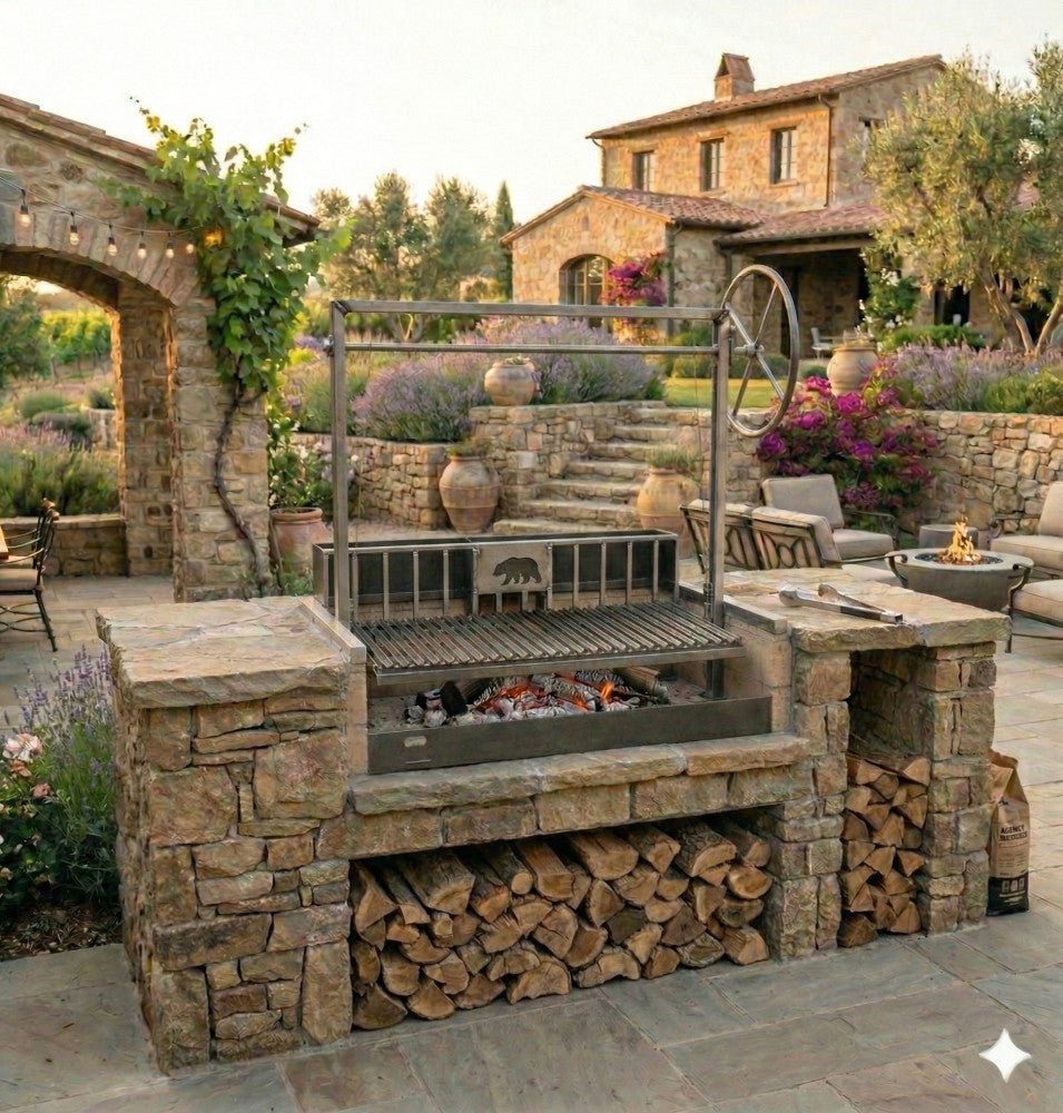 Outdoor kitchen featuring a Stainless Steel Argentine grill with rear brasero and 3-sided flange built into a stone masonry firebox, ready for wood-fired grilling.