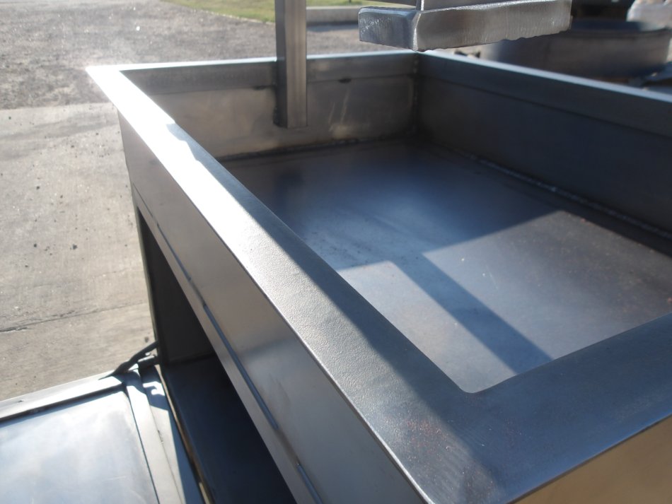 Close-up of Stainless Steel Charcoal Grill Surface and Firebox Detail