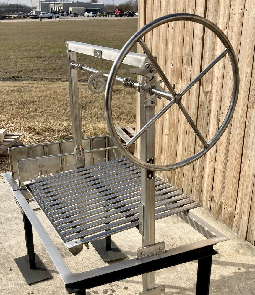 Stainless steel Argentine grill frame with height-adjustable V-grate and heavy-duty brasero, designed for masonry firebox installations.