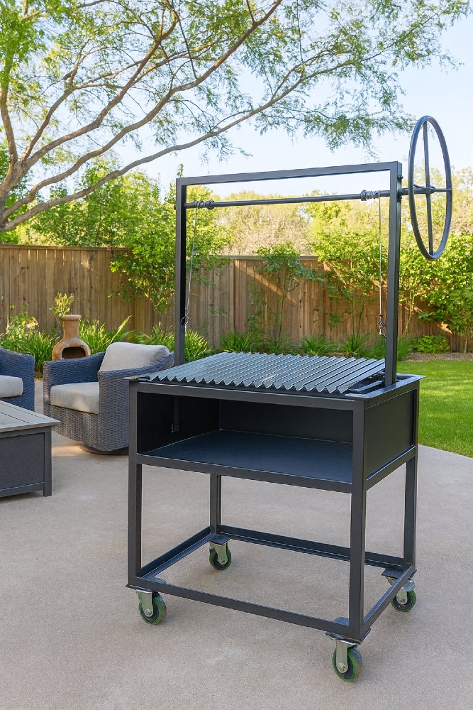 Argentine BBQ Grill with open firebox and casters displayed on a stone patio surrounded by outdoor furniture and greenery.