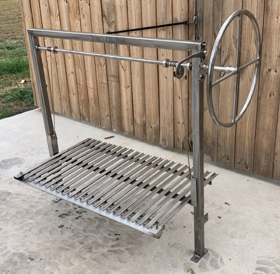 Adjustable Argentine BBQ grill kit with Argentine V-grate with drip pan and wheel height control for wood or charcoal cooking in a masonry firebox