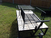 Exhibition Fire Table with All Terrain Casters, Small Asado Grill, Heavy Duty Large Brasero, and a Three-Sided Hinged Wind Block