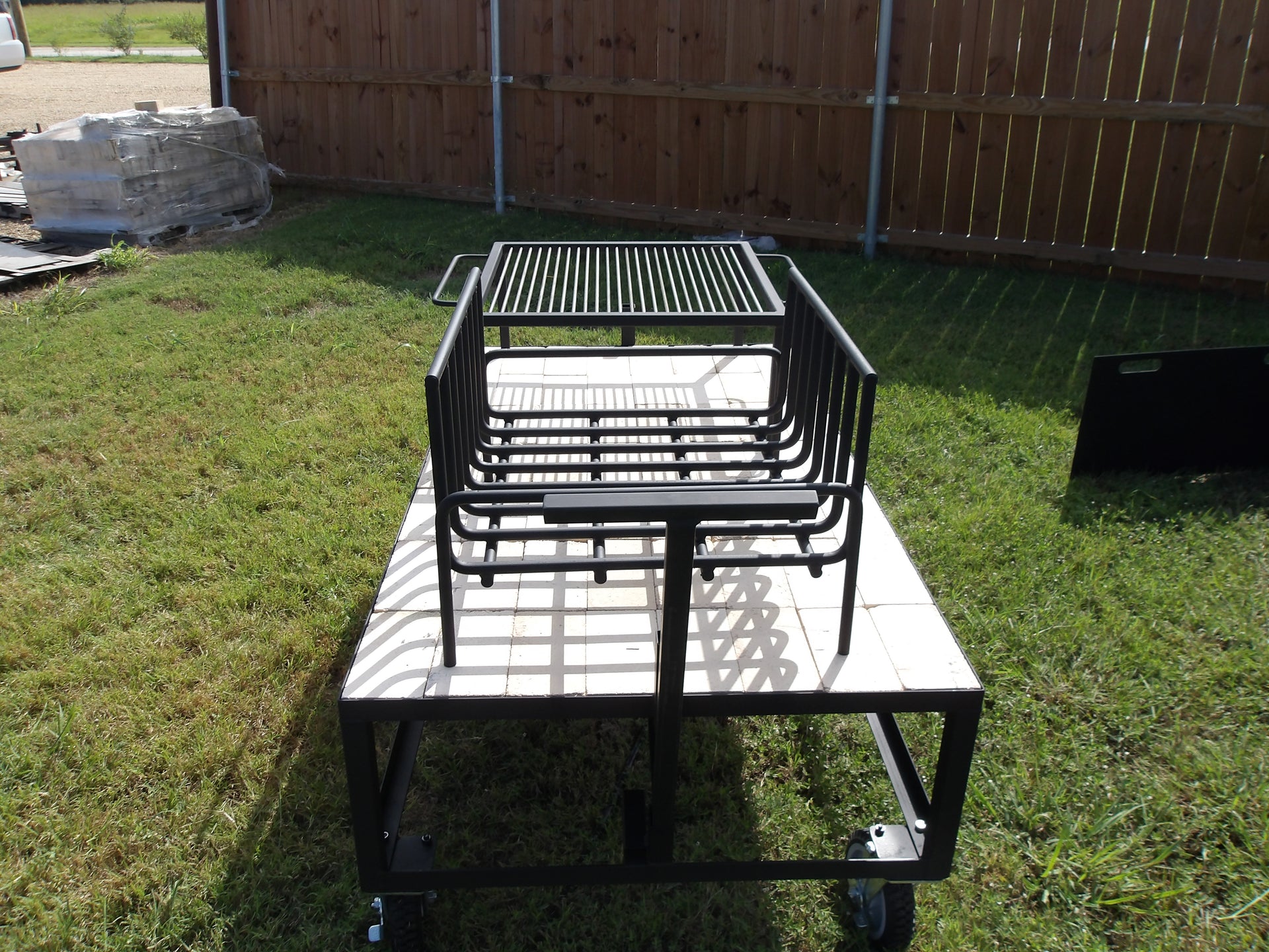 Exhibition Fire Table with All Terrain Casters, Small Asado Grill, Heavy Duty Large Brasero, and a Three-Sided Hinged Wind Block