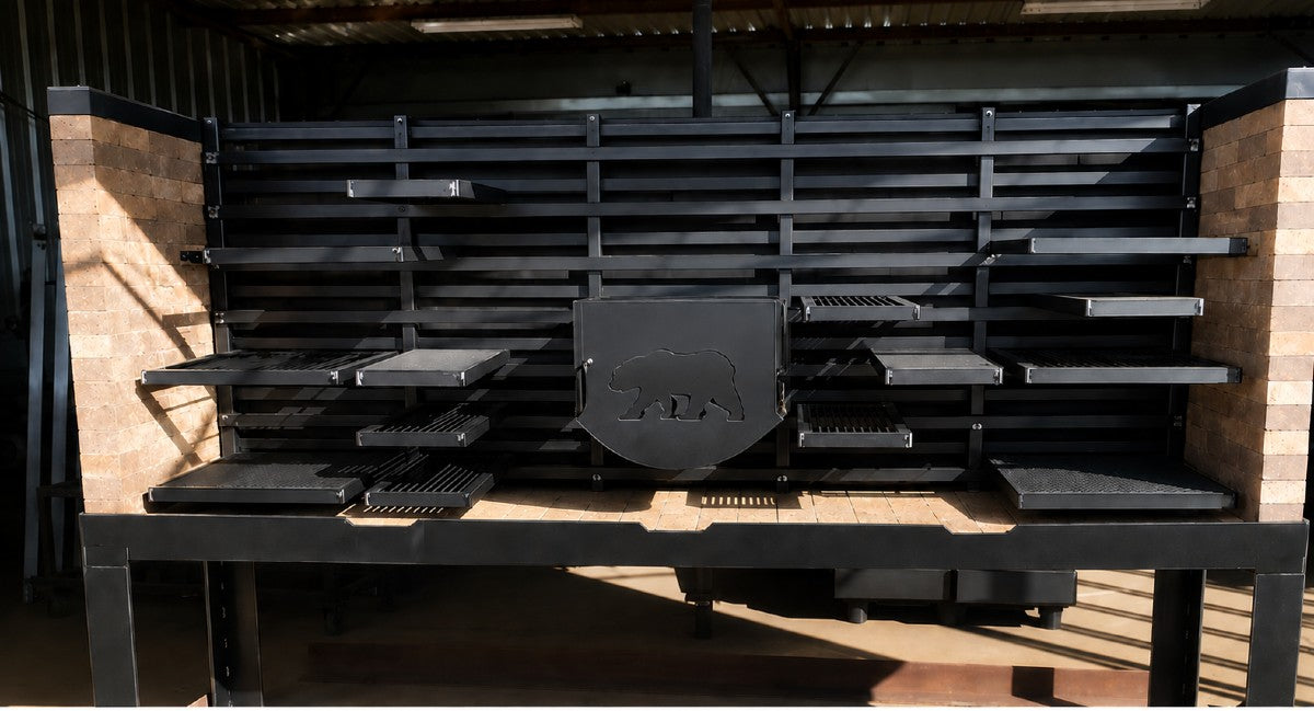 #2991 Commercial Modular Live-Fire Cooking System with Pinch System, featuring a brick-lined fire table, multiple adjustable cooking surfaces, and modular cooking rails for professional live-fire cooking.