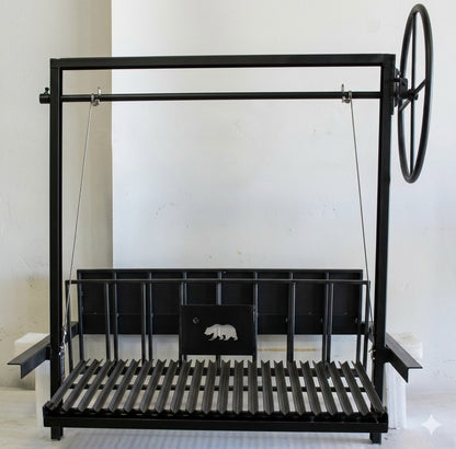 Black steel Argentine grill with rear brasero and 3-sided flange, featuring an adjustable V-grate and side wheel for wood or charcoal grilling.