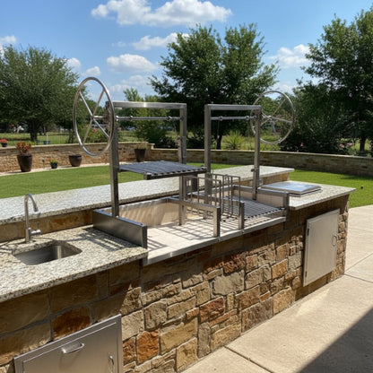 Split Stainless Argentine Grill with Center Ember Maker built into outdoor kitchen, featuring independent grates and handcrafted steel firebox. Includes a  Stainless Tool Set.