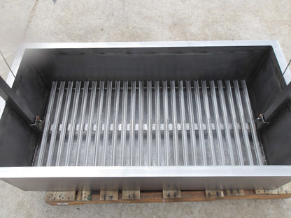 Interior view of stainless Santa Maria built-in grill with adjustable round rod grilling grate and heavy-duty firebox for wood or charcoal cooking.
