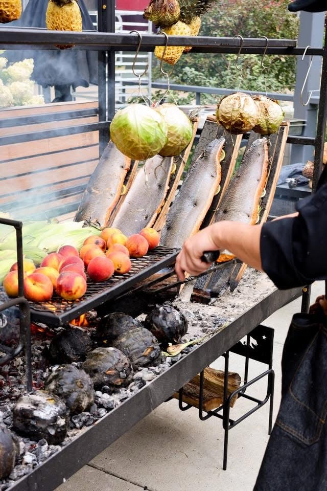Grilling peaches, corn, and cabbage on Portico open-fire BBQ grill with wood embers