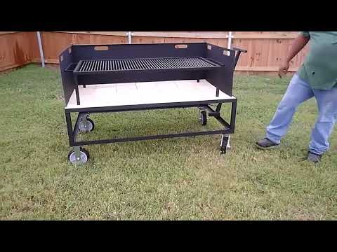 Exhibition Fire Table with All Terrain Casters, Small Asado Grill, Heavy Duty Large Brasero, and a Three-Sided Hinged Wind Block