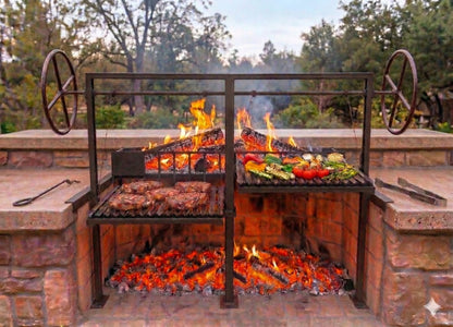 Split Argentine grill with rear brasero installed in an open front masonry firebox for traditional wood fired live fire grilling.