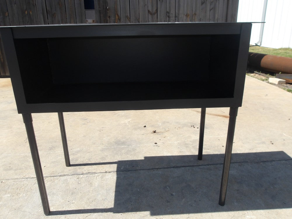 Front detail of wood stove grill with dual 16 inch fire plates and steel leg support, outdoor freestanding design